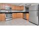 Bright kitchen features stainless steel appliances and wooden cabinets at 10330 Carrollwood Ln # 95, Tampa, FL 33618