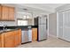 Bright kitchen features stainless steel appliances and wooden cabinets at 10330 Carrollwood Ln # 95, Tampa, FL 33618