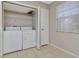 The laundry room features a washer, dryer, shelf, and window with blinds at 10330 Carrollwood Ln # 95, Tampa, FL 33618