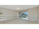 Spacious living area with sliding glass doors leading to a balcony with a scenic water view at 10330 Carrollwood Ln # 95, Tampa, FL 33618