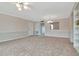 A carpeted living room with a doorway and built-in bookshelf at 10330 Carrollwood Ln # 95, Tampa, FL 33618