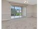 Spacious living area with sliding glass doors leading to a balcony with a scenic water view at 10330 Carrollwood Ln # 95, Tampa, FL 33618