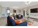 Well-lit living room with stylish blue furniture, rug, and open layout to the dining area at 10330 Carrollwood Ln # 95, Tampa, FL 33618