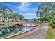 Picturesque community pond featuring a charming walking bridge and serene water views at 10330 Carrollwood Ln # 95, Tampa, FL 33618