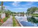 Scenic pond view with a meandering walkway, community fountain, and vibrant landscaping at 10330 Carrollwood Ln # 95, Tampa, FL 33618