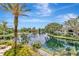 Beautiful water view featuring a fountain, landscaping, and a patio seating area at lakeside condominiums at 10330 Carrollwood Ln # 95, Tampa, FL 33618