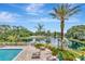Community pool and lounge area overlooking a scenic pond with a fountain, perfect for relaxation at 10330 Carrollwood Ln # 95, Tampa, FL 33618
