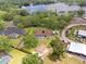 Aerial view of a home with a pool and lush backyard near a serene lake, offering privacy and natural beauty at 10502 Lake Williams Dr, Odessa, FL 33556