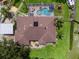 Bird's eye view of a home with screened pool and a spacious yard at 10502 Lake Williams Dr, Odessa, FL 33556