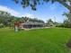 Expansive backyard with a screened pool, playground, and lush green lawn at 10502 Lake Williams Dr, Odessa, FL 33556