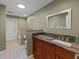 Bathroom with a large vanity, mirror, and toilet and shower area with skylight at 10502 Lake Williams Dr, Odessa, FL 33556