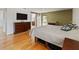 Primary bedroom with a barn door leading to the en-suite bathroom and a view to the backyard at 10502 Lake Williams Dr, Odessa, FL 33556