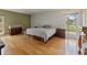 Comfortable bedroom featuring hardwood floors and ample natural light with two windows at 10502 Lake Williams Dr, Odessa, FL 33556