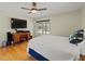 Bright bedroom with a ceiling fan, desk, and sliding glass doors to the pool at 10502 Lake Williams Dr, Odessa, FL 33556