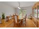 Bright dining room with natural light, hardwood floors, and classic wood furnishings at 10502 Lake Williams Dr, Odessa, FL 33556