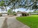 Long driveway leading to a two-car garage and a covered parking area at 10502 Lake Williams Dr, Odessa, FL 33556