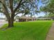 Well-kept property showcasing its large yard with mature trees and landscaping at 10502 Lake Williams Dr, Odessa, FL 33556