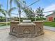 Outdoor kitchen with large stone island and grill overlooking the backyard at 10502 Lake Williams Dr, Odessa, FL 33556