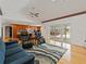 Open-concept living room with hardwood floors, a view of the kitchen, and access to the outdoor pool area at 10502 Lake Williams Dr, Odessa, FL 33556