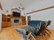 Cozy living room with a brick fireplace, built-in shelves, and a large ceiling fan at 10502 Lake Williams Dr, Odessa, FL 33556