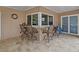Enjoy this outdoor bar with seating for four and tile floors inside a screened enclosure at 10502 Lake Williams Dr, Odessa, FL 33556