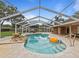 Screened in pool with waterfall feature, lounge chairs, and travertine tile deck at 10502 Lake Williams Dr, Odessa, FL 33556