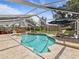 Gorgeous swimming pool with a rock waterfall feature, sun loungers, and a nearby spa at 10502 Lake Williams Dr, Odessa, FL 33556
