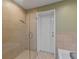 Shower enclosure with frameless glass doors and side panels and a view of the backyard at 10502 Lake Williams Dr, Odessa, FL 33556