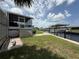 Well-maintained backyard with green grass, a boat lift, and access to the canal at 108 W Saint Annes Cir, Apollo Beach, FL 33572