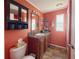 Bathroom with modern vanity, mirror, decorative elements and adjacent toilet at 108 W Saint Annes Cir, Apollo Beach, FL 33572