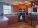 Well-equipped kitchen with wood cabinets and stainless steel appliances at 108 W Saint Annes Cir, Apollo Beach, FL 33572