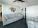 Comfortable living room with neutral-colored sofa, side chair, and nautical decor at 108 W Saint Annes Cir, Apollo Beach, FL 33572