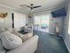 Cozy living room with a sofa, chair, and sliding door access to outdoor patio at 108 W Saint Annes Cir, Apollo Beach, FL 33572