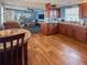 Open-concept living area with wood floors, a kitchen island, and comfortable seating at 108 W Saint Annes Cir, Apollo Beach, FL 33572