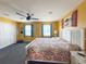 Bright bedroom with large bed and ceiling fan at 108 W Saint Annes Cir, Apollo Beach, FL 33572