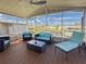 Covered patio with modern furniture and views of the canal, perfect for relaxing and entertaining guests at 108 W Saint Annes Cir, Apollo Beach, FL 33572