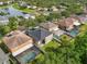 Aerial view of a suburban neighborhood with mature trees and a community pond at 11132 Creek Haven Dr, Riverview, FL 33569