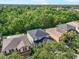 An aerial view showcases well-maintained homes surrounded by lush green trees at 11132 Creek Haven Dr, Riverview, FL 33569