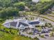 Aerial view of modern building with solar panels on the roof and large parking at 11132 Creek Haven Dr, Riverview, FL 33569
