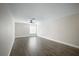Large, bright bedroom featuring wood flooring, ceiling fan, and two windows at 11132 Creek Haven Dr, Riverview, FL 33569