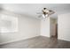 Spacious room with wood flooring, ceiling fan, neutral walls and a large window at 11132 Creek Haven Dr, Riverview, FL 33569