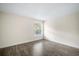 A neutral-toned bedroom with wood-look floors and a sunlit window at 11132 Creek Haven Dr, Riverview, FL 33569