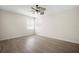 Bright bedroom with wood flooring, ceiling fan, and natural light from windows at 11132 Creek Haven Dr, Riverview, FL 33569