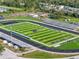 Scenic aerial view of a well-maintained football field and track, perfect for sports and recreation at 11132 Creek Haven Dr, Riverview, FL 33569