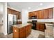 The kitchen features stainless steel refrigerator, brown cabinets, granite countertops, and a center island at 11132 Creek Haven Dr, Riverview, FL 33569