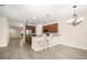 Open kitchen with brown cabinets, granite countertops, island with bar seating, and wood-look floors at 11132 Creek Haven Dr, Riverview, FL 33569