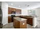 Kitchen with brown cabinets, granite countertops, and an island, open to the dining area at 11132 Creek Haven Dr, Riverview, FL 33569