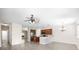 Open-concept living room featuring wood floors, ceiling fan, kitchen bar and dining nook at 11132 Creek Haven Dr, Riverview, FL 33569