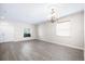 Bright living room with gray wood-look floors, light-colored walls, and natural light at 11132 Creek Haven Dr, Riverview, FL 33569