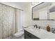 Stylish bathroom featuring a marble vanity, a shower with a patterned curtain, and modern fixtures at 11829 104Th St, Largo, FL 33773